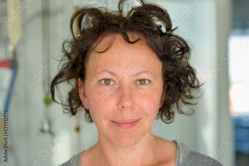 Hispanic woman with tousled curly hair