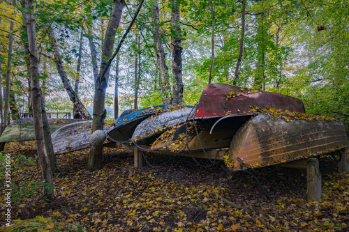 Abandoned boats on land in the forest.