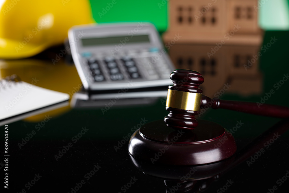 Labour law and builiding law concept. Gavel and yellow crash helmet on the shining lawer desk. Labour law and builiding law concept. Gavel and yellow crash helmet on the shining lawer desk.