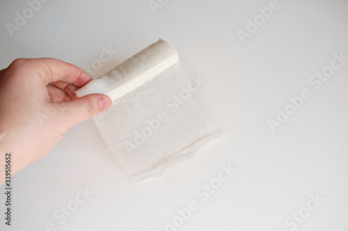 Medical bandage in hands on a white background