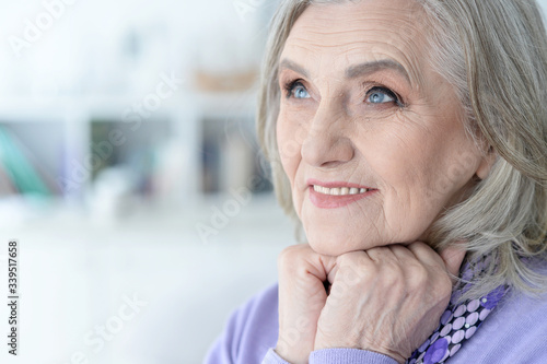 Portrait of happy beautiful senior woman posing at home