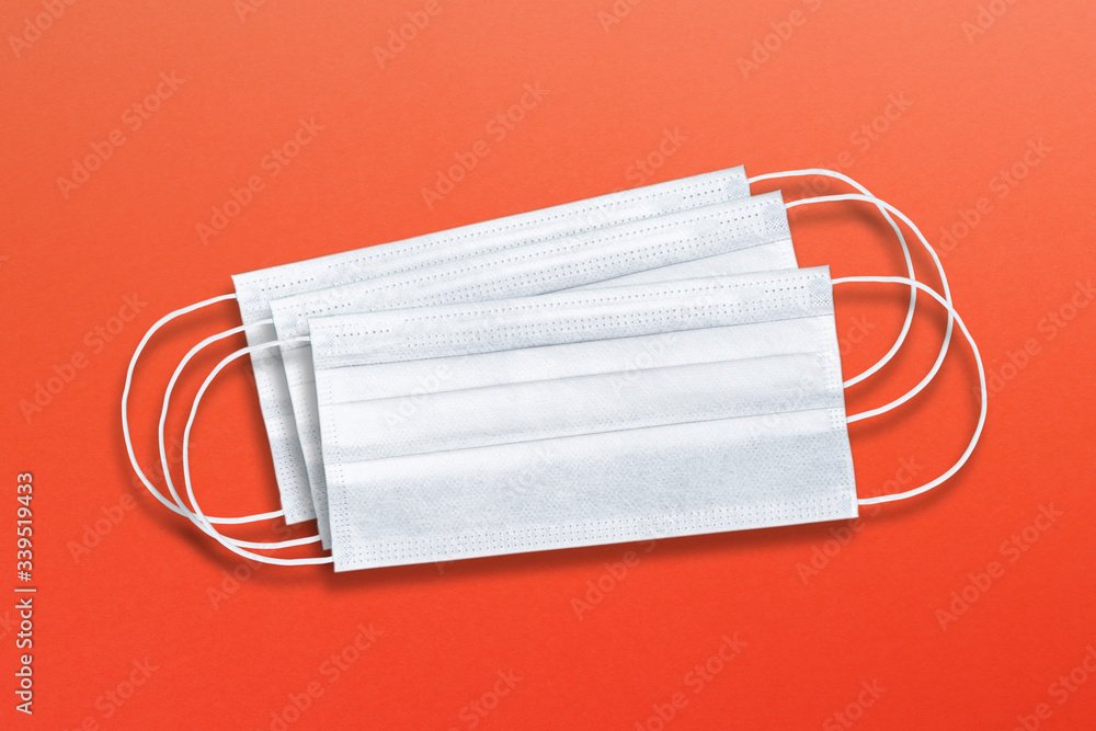 Medical masks, surgical face masks on red background Medical masks, surgical face masks on red background