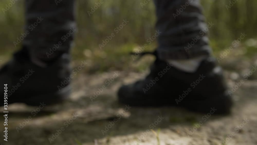 Hiking in the bright spring forest. Unrecognizable shoes close-up gimbal, steadicam smooth 4K. Hiking in the bright spring forest. Unrecognizable shoes close-up gimbal, steadicam smooth 4K.