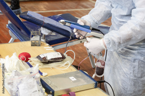 A doctor takes a bag of donated blood