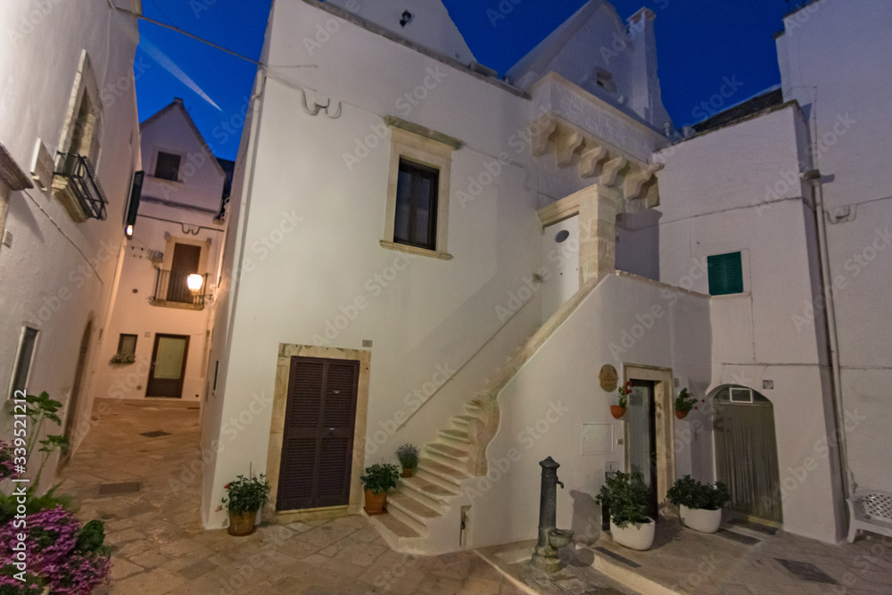 Fototapeta premium Night view of the streets of the historic center of the white town of Locorotondo in Puglia, Italy.