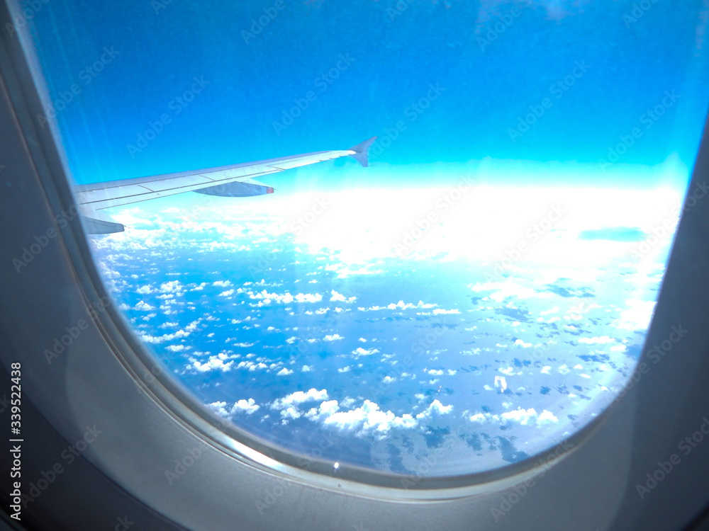 Cropped Image Of Airplane Against Sky Seen Through Window