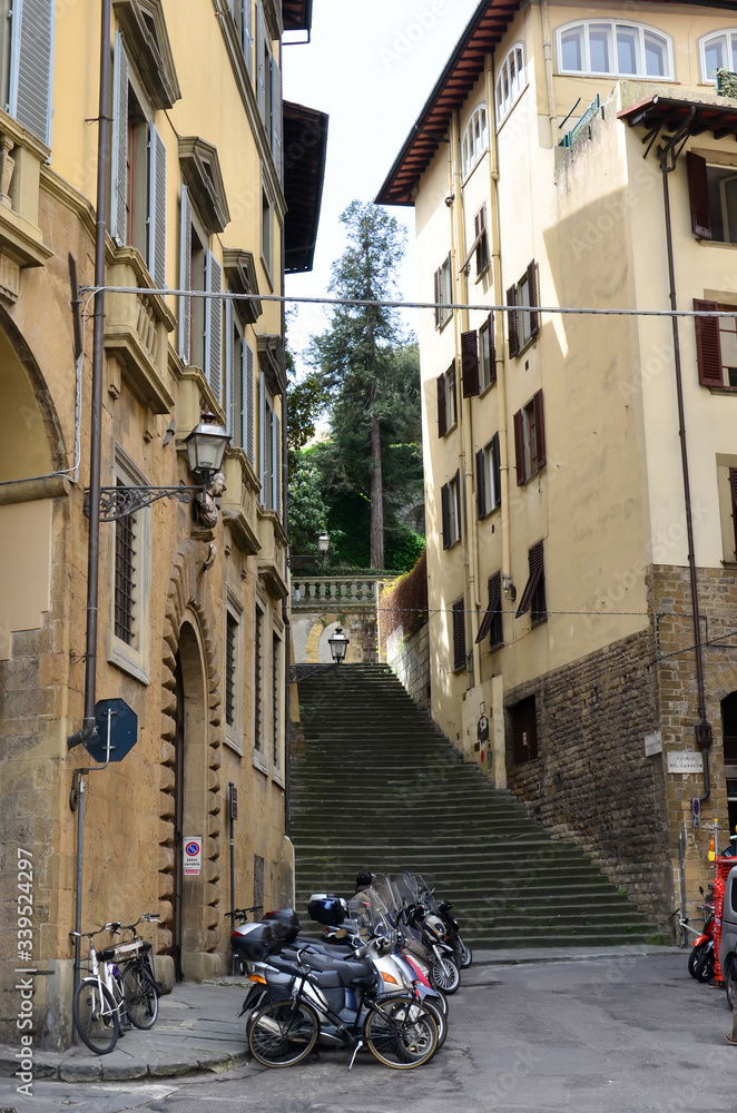 Sunny alley in Florence wiht 
motorcycle, Italy