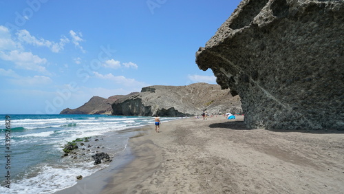 Spain Mediterranean coast in Andalusia, sandy beach shore with volcanic rock formation, Playa de Monsul, Cabo de Gata Nijar natural park, Almeria photo