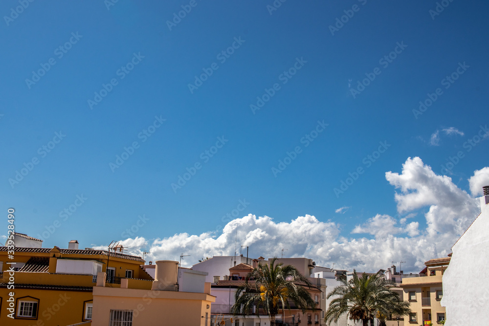 image of roofs with blue sky with clouds in the background. Image taken in quarantine confinement by COVID-19