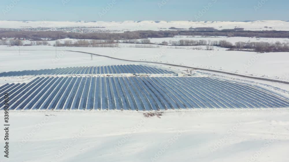 Aerial perspective Solar panel farm Green Energy at winter snow sunny day drone shot of Ecology Power Conservation Aerial perspective Solar panel farm Green Energy at winter snow sunny day drone shot of Ecology Power Conservation