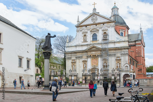 St. Peter and Paul Church with statues of saints on the Grodka Street in the Old Town of Krakow. A memorial of Jesuit priest Piotr Skargaon the St. Mary Magdalene Square. © Yana