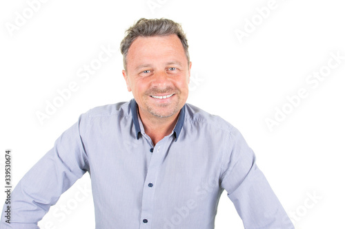 Smiling young bearded man in blue shirt posing isolated on white wall background studio portrait