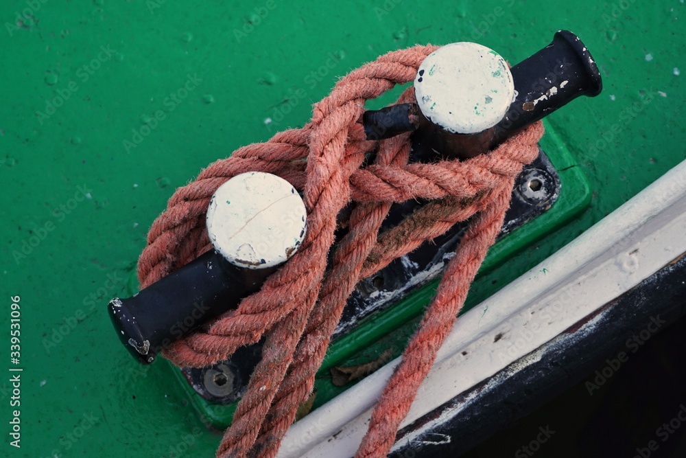 Stowage and bollard on a green ship deck