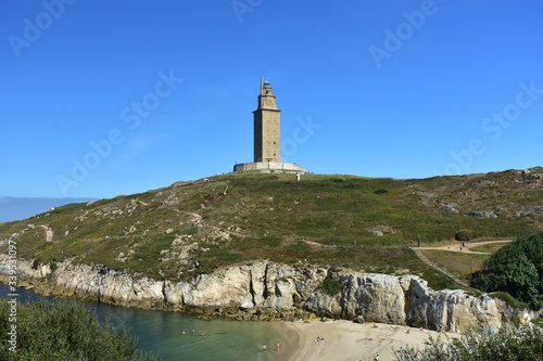 Torre de Hercules or Tower of Hercules with beach and blue sky. A Coruña, Galicia, Spain.