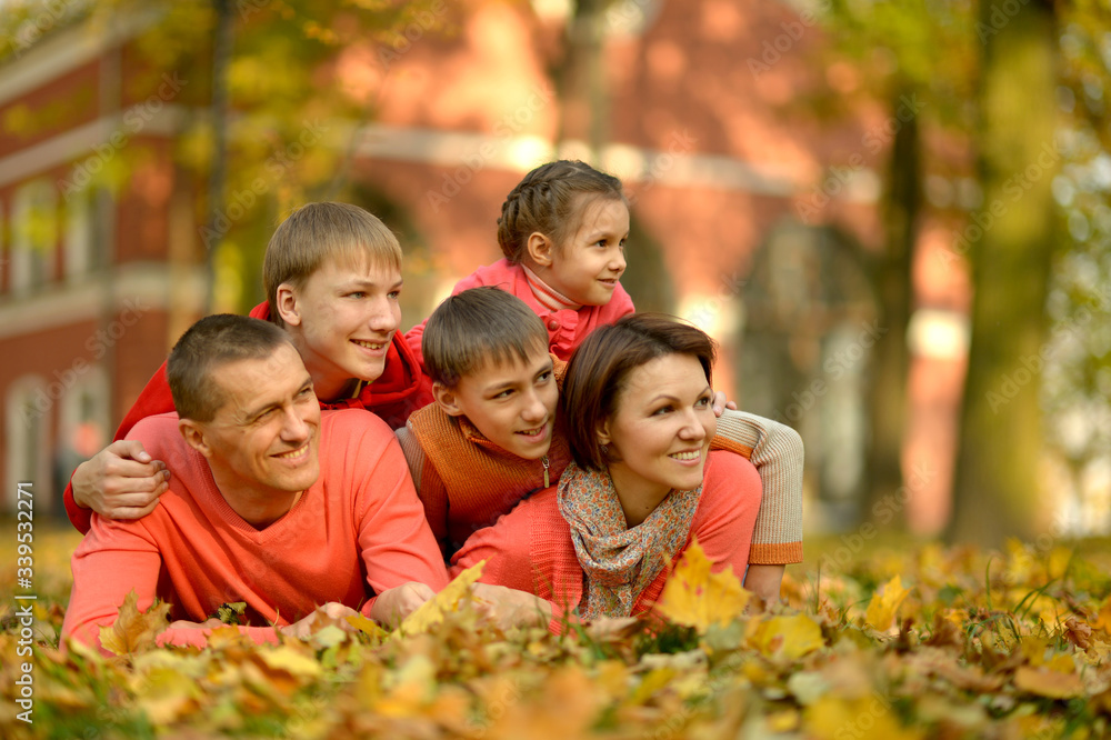 Portrait of family relaxing in autumn park Portrait of family relaxing in autumn park