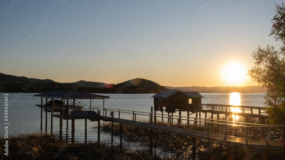 Fototapeta premium pier at Clare lake at sunset, california