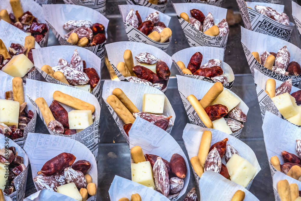 Bar shop window with chorizo, crackers and cheese cones in Madrid city, Spain Bar shop window with chorizo, crackers and cheese cones in Madrid city, Spain