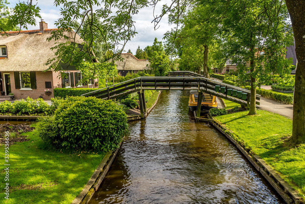 Typical Dutch houses and gardens in Giethoorn, The Netherlands Typical Dutch houses and gardens in Giethoorn, The Netherlands
