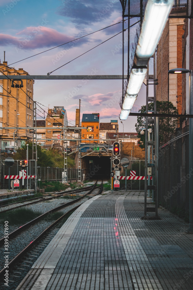 Fototapeta tren station in sunset with beautiful sky