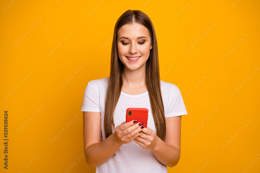 Portrait of positive cheerful girl use smartphone read search social network novelty wear style stylish good look clothes isolated over bright shine color background Portrait of positive cheerful girl use smartphone read search social network novelty wear style stylish good look clothes isolated over bright shine color background