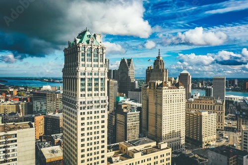 Cityscape of Detroit under the sunlight and a dark cloudy sky at daytime in Michigan in the US photo