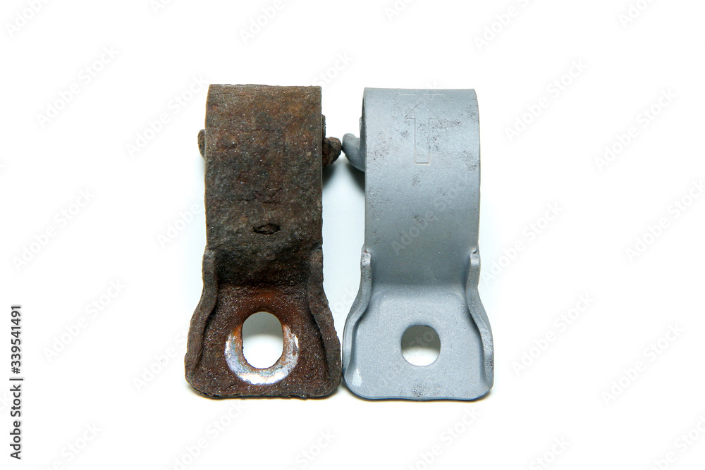 The overgrown rusty cast iron part compared with the same sand blasted part isolated in a white background. The overgrown rusty cast iron part compared with the same sand blasted part isolated in a white background.