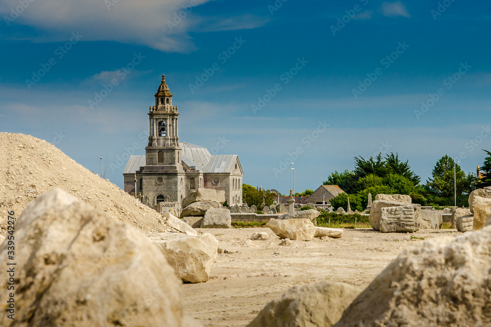 St Georges Church viewed from across a quarry for Portland stone, Isle of Portland, Dorset, UK on a sunny Summer afternoon