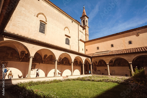 Tourists walking on corridors of the cloister of 15th century monastery Convent of San Marco at sunny day