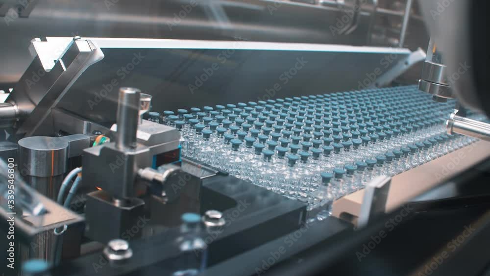 Sterile bottles and vials on the line of the pharmaceutical plant for the production of medical drugs, Medicine, pharmaceuticals, Covid-19. Sterile bottles and vials on the line of the pharmaceutical plant for the production of medical drugs, Medicine, pharmaceuticals, Covid-19.