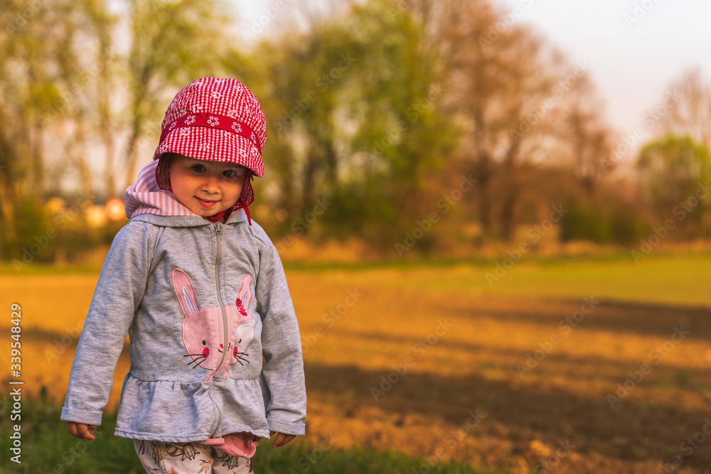Cute little girl having fun at countryside portrait on sunset Cute little girl having fun at countryside portrait on sunset
