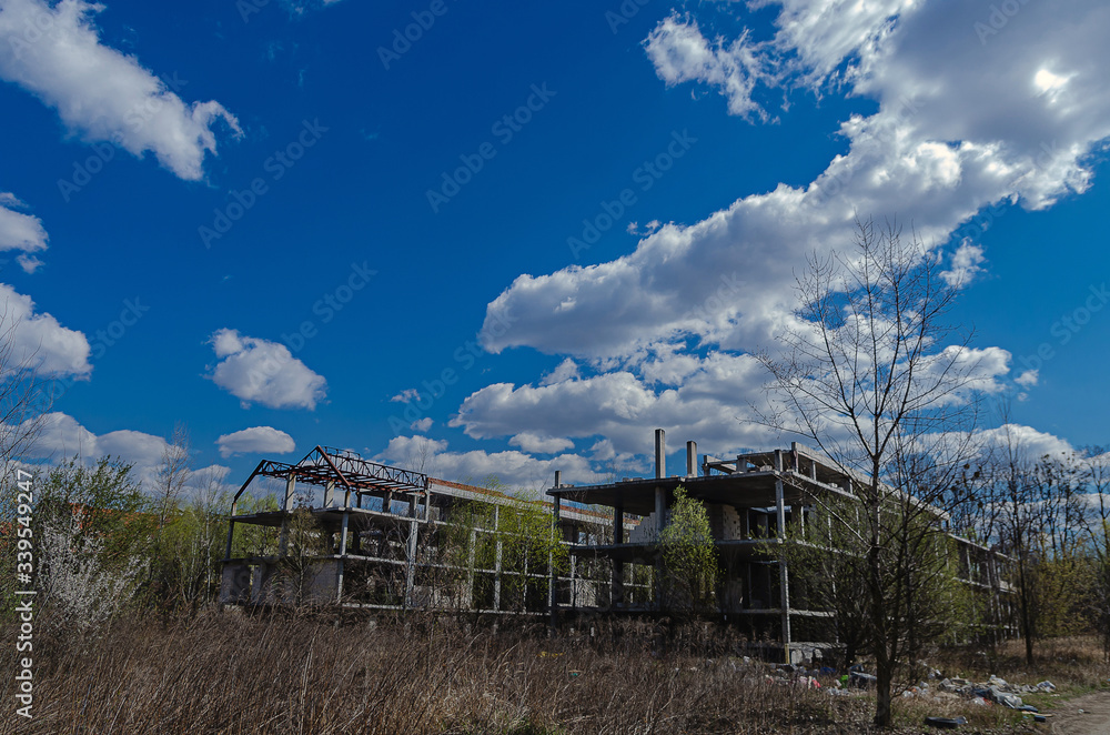 Abandoned construction site of a residential complex. Skeletons of apartment buildings. Construction in progress. Bankruptcy of an investment construction company Abandoned construction site of a residential complex. Skeletons of apartment buildings. Construction in progress. Bankruptcy of an investment construction company