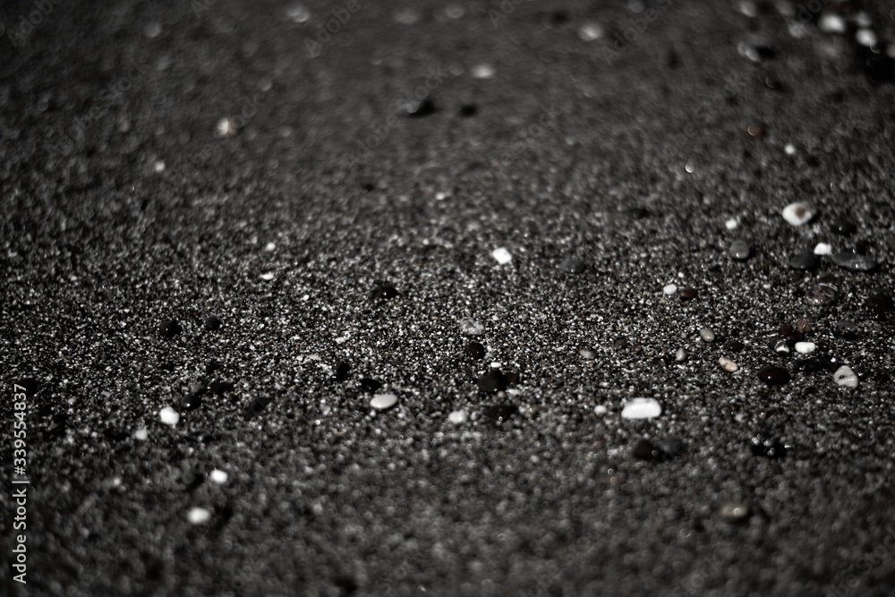 black sand volcanic beach stones sea ocean shore close-up diffuse black sand volcanic beach stones sea ocean shore close-up diffuse