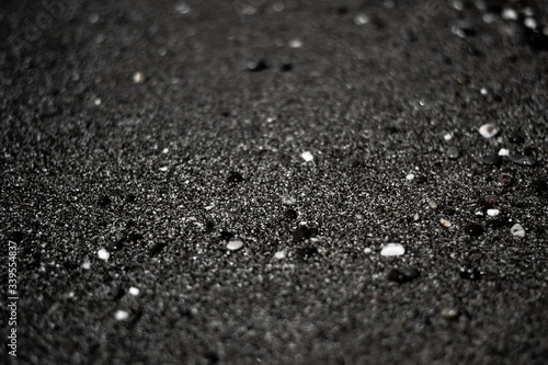 black sand volcanic beach stones sea ocean shore close-up diffuse 