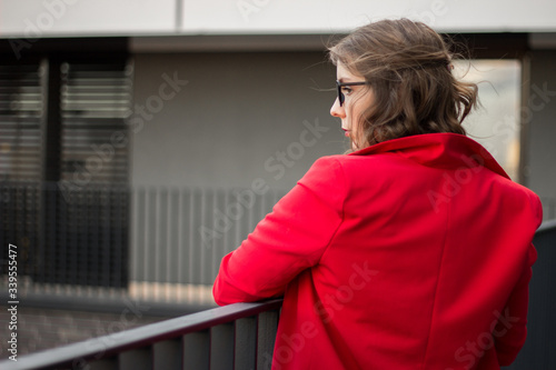 A young businesswoman thinking about something on her balcony 