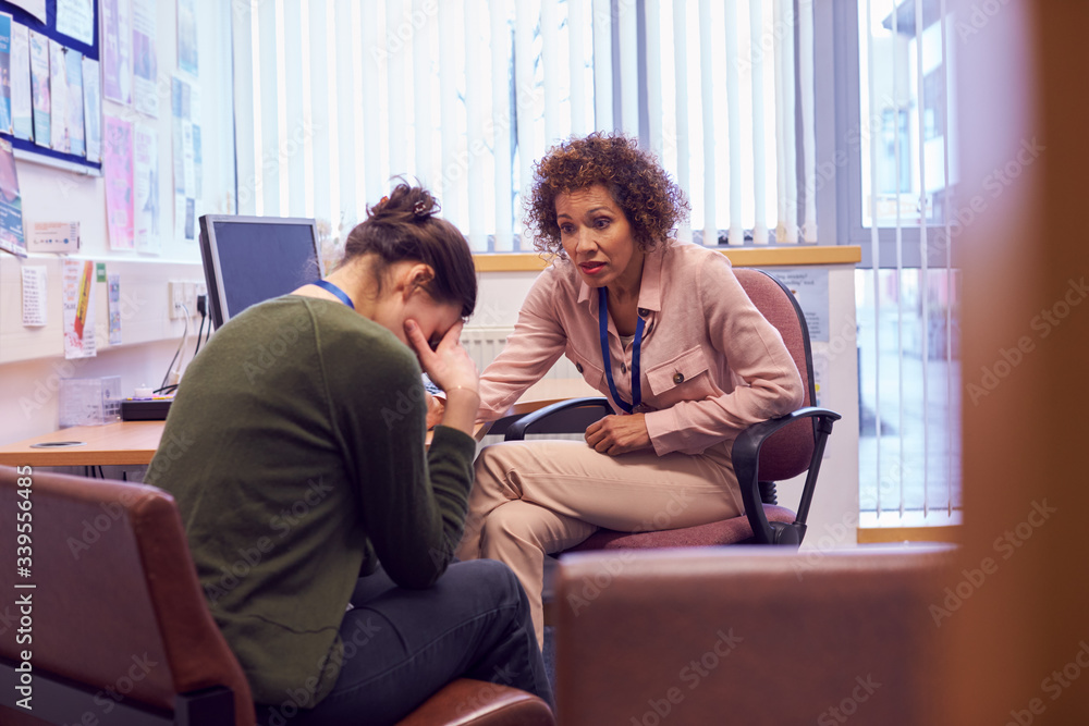 Female College Student Meeting With Campus Counselor Discussing Mental 