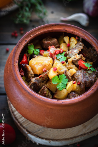 Roast in a clay pot. Braised beef with vegetables. A dish of Georgian cuisine. Chanahi photo