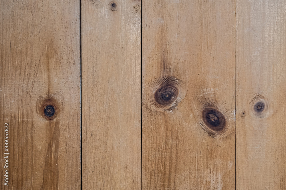 Rustic, natural, knotty pine boards on a wall in a vertical composition Rustic, natural, knotty pine boards on a wall in a vertical composition