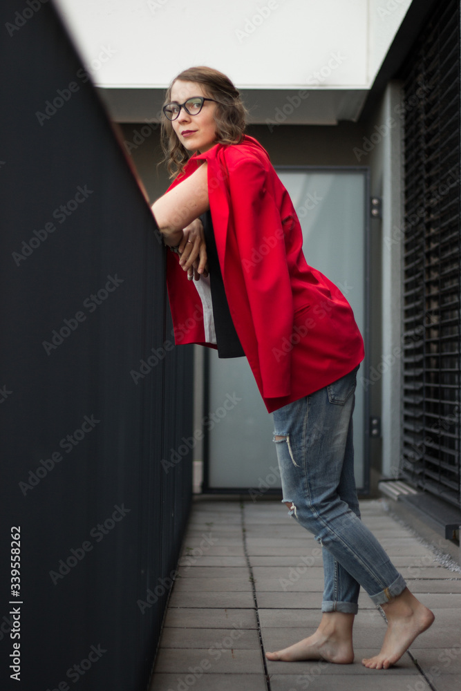 A young businesswoman thinking about something on her balcony
A young businesswoman thinking about something on her balcony