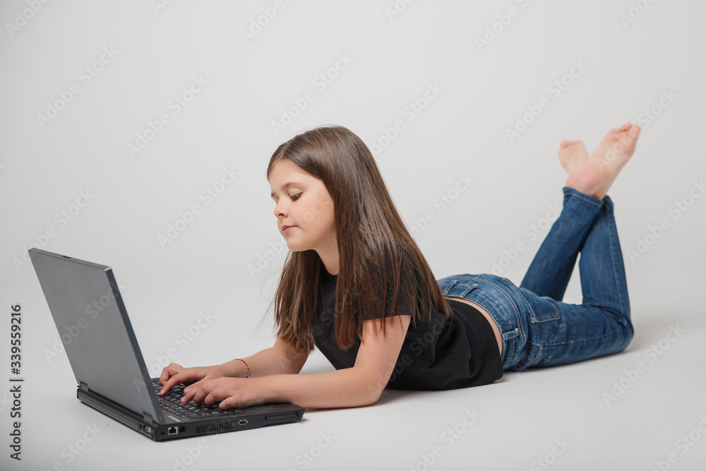 girl is engaged on a laptop remotely on a white background girl is engaged on a laptop remotely on a white background