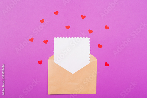 Valentine's day love letter mockup. Mother's Day letter mock up. Craft envelope with white blank card and hearts on purple background. Holiday greetings concept. Free space. Space for text.  © Anna Niki