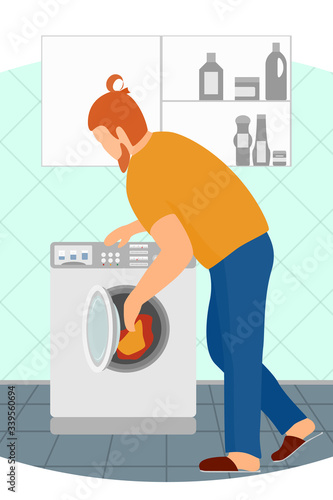 A man loads dirty laundry into a washing machine. Homework - washing clothes. Gender equality. Laundry room with automatic appliances, sets of detergents in the closet.