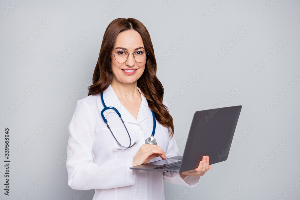 Photo of professional family doc lady work modern technology notebook laptop writing patient prescription quarantine wear specs stethoscope white lab coat isolated grey color background Photo of professional family doc lady work modern technology notebook laptop writing patient prescription quarantine wear specs stethoscope white lab coat isolated grey color background