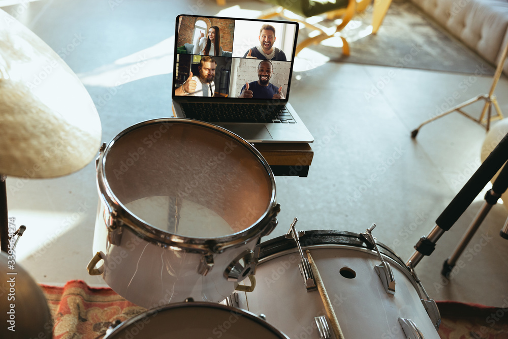 Fototapeta premium Caucasian musician playing drumms during online concert at home isolated and quarantined. Using camera, laptop, streaming, recording courses. Concept of art, support, music, hobby, education.