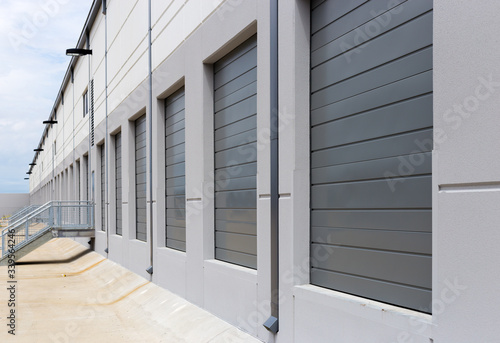 Empty warehouse loading dock white walls gray metal sliding doors