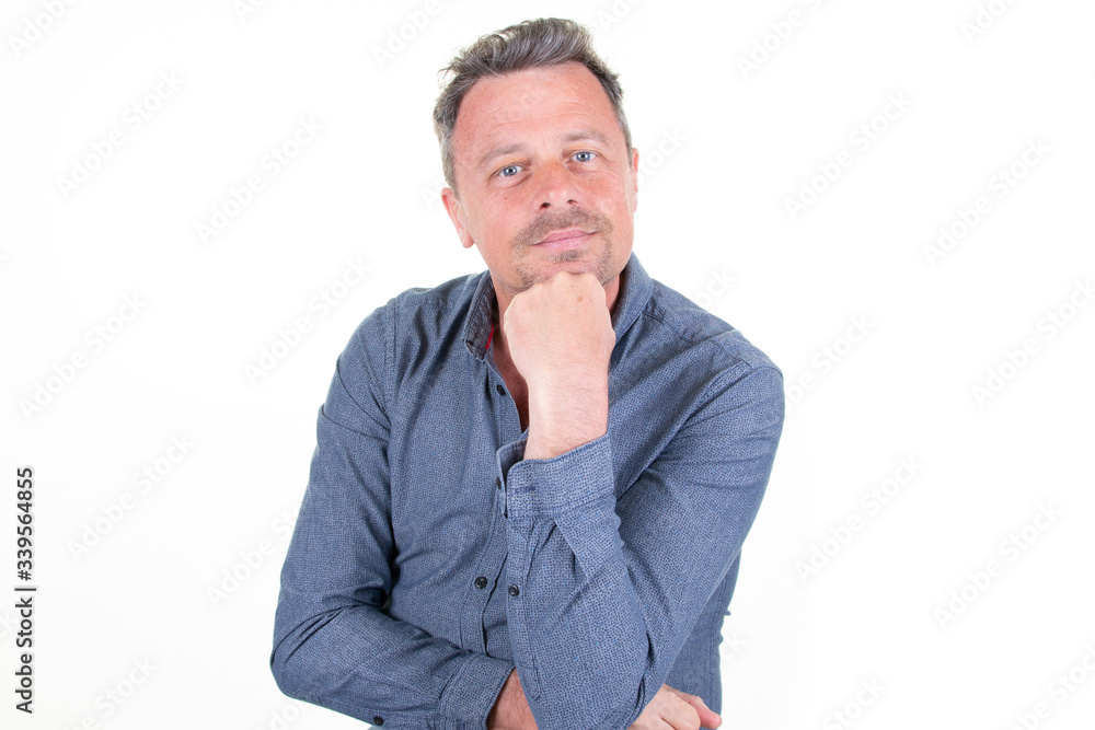 handsome man smiling with hand on chin over white background handsome man smiling with hand on chin over white background