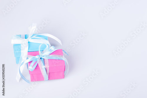 Two gift boxes blue and pink color with ribbon bow on white background