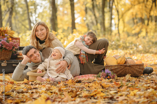 A family with two daughters went on a picnic. Autumn time.