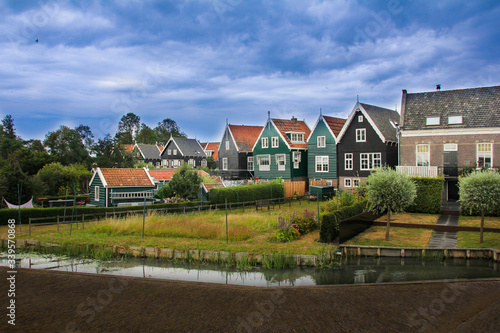 Colorful houses in Marken with a canal past it