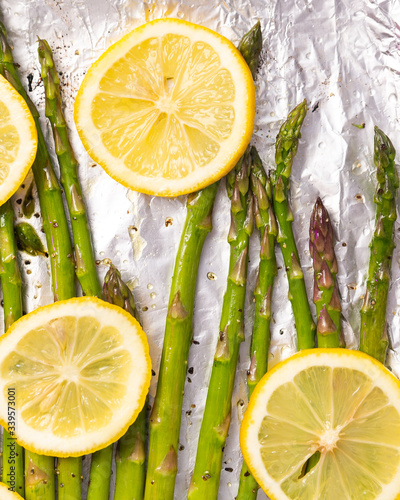 Asparagus and lemon slices on a baking tray