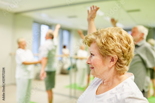 Sporty senior woman in back exercises